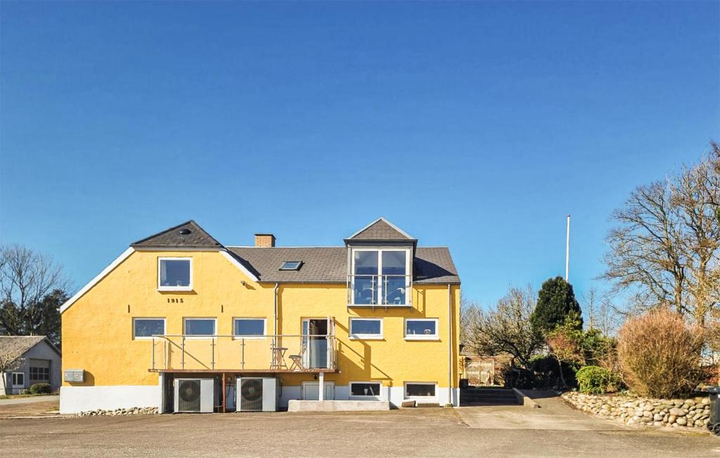 a yellow house with a black roof at Stunning Apartment In Holstebro With Wifi in Holstebro
