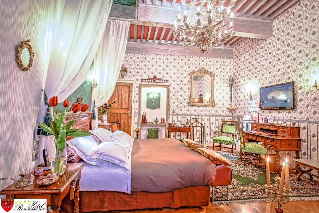 um quarto com uma cama grande e um piano em Hôtel Renaissance em Castres