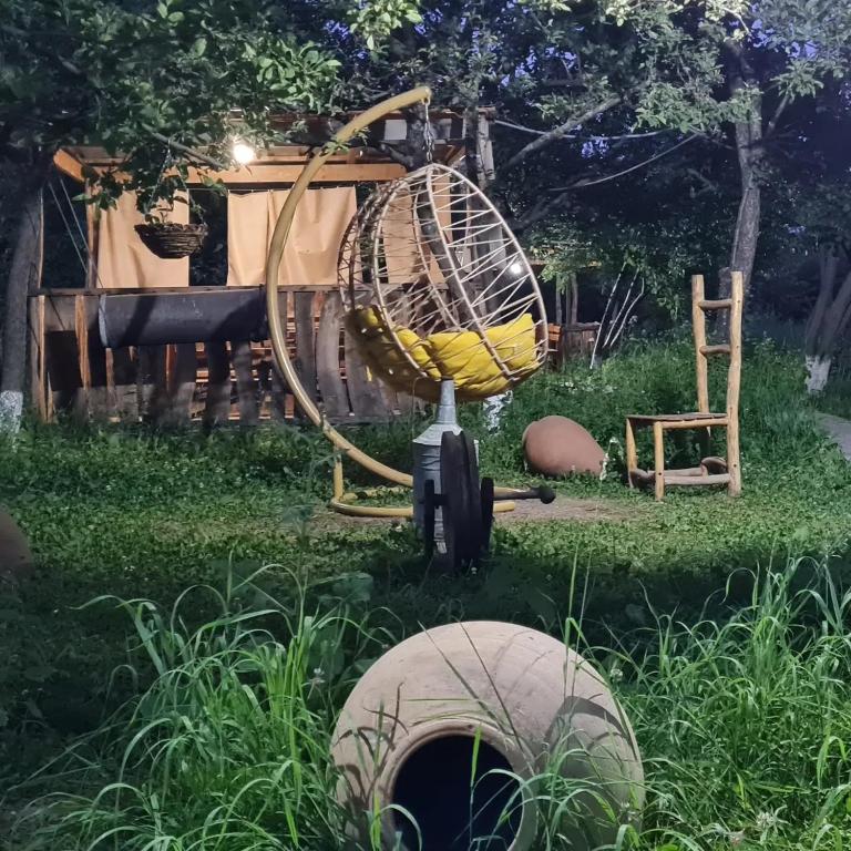 a garden with an old fashioned wheel and a swing at Mirage Hotel in Shinuhayr