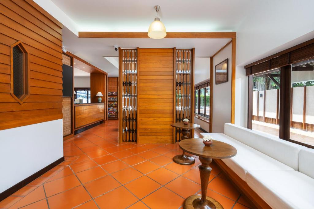 A long window-side lounge with a built-in sofa and small café tables.