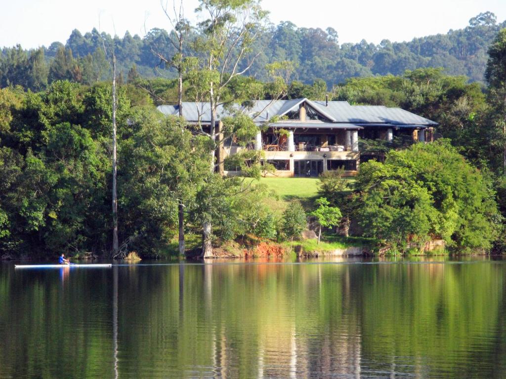 a house on the shore of a lake at Tinkers Lakeside Lodge - Kruger in White River
