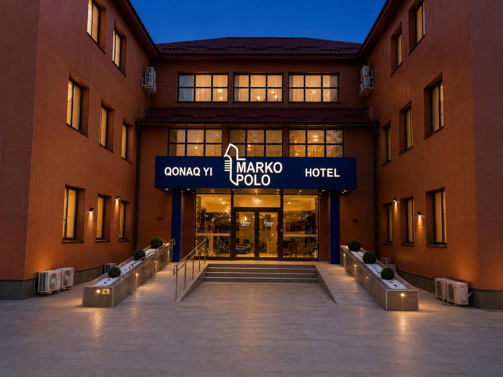 a large building with a sign that reads camino hotel at Marko Polo Hotel in Aksay