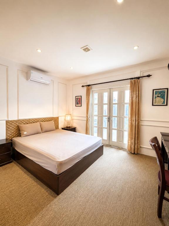 a bedroom with a large bed and a window at X-Stay Cloud in Hai Phong