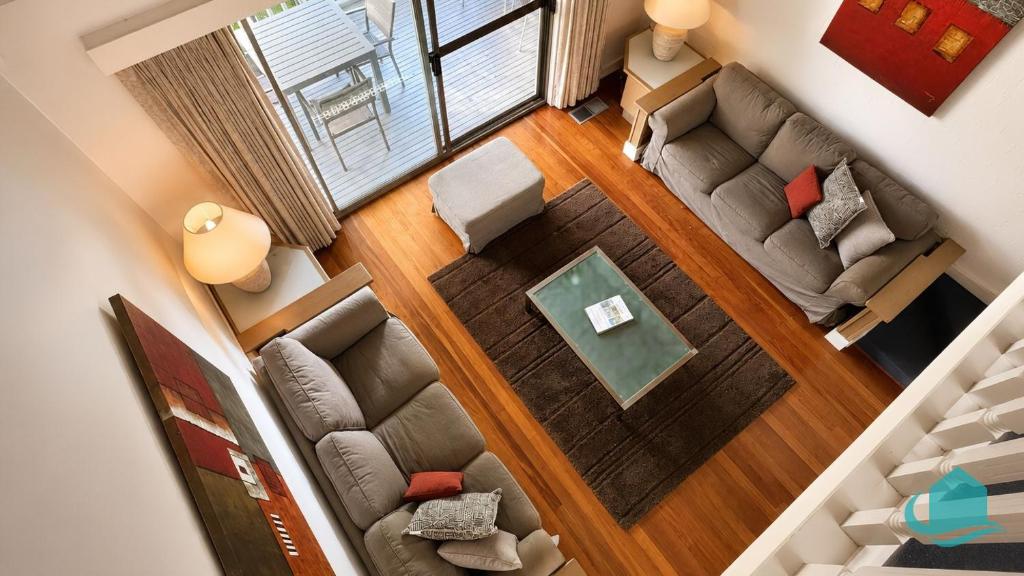 an overhead view of a living room with two couches at Plover Executive Deluxe Villa 25 in Cams Wharf