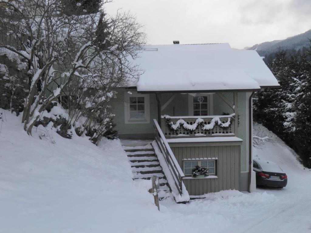 a house in the snow with a snow covered porch at Ferienhaus Forsthof in Taxenbach