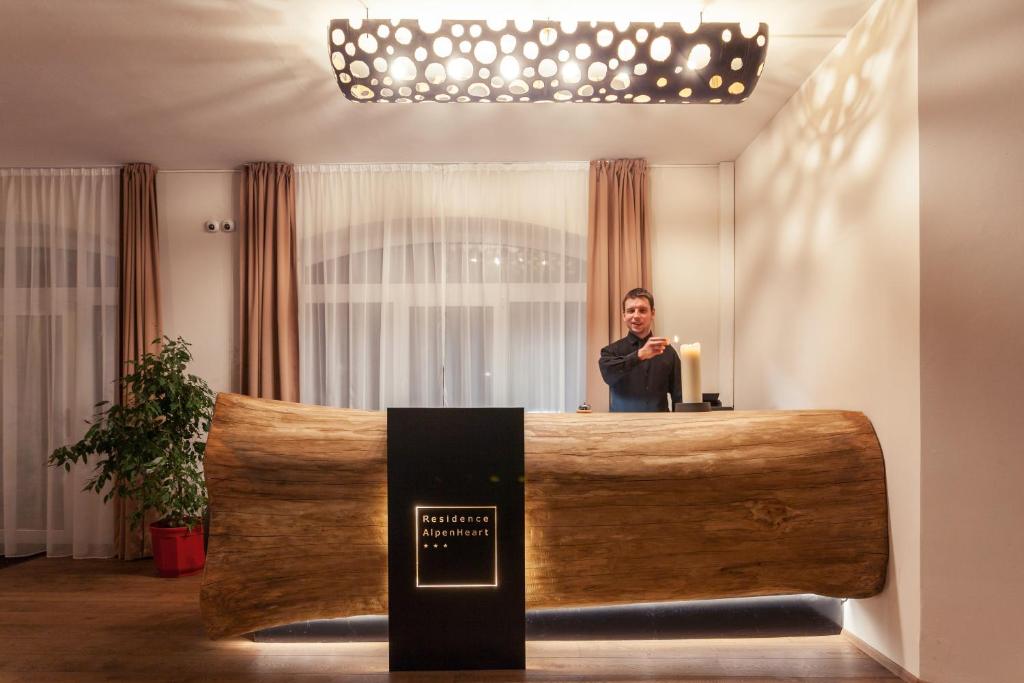 a man standing at a podium in a room at Residence AlpenHeart in Bad Gastein