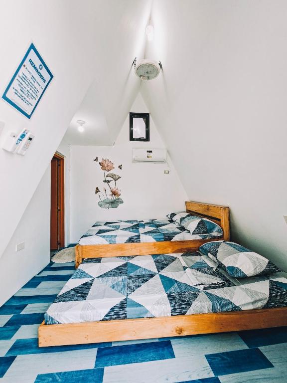 a bedroom with a bed in a attic at Laofoo Island Resort in Bued