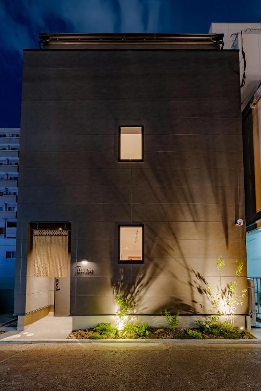 a building with lights on the side of it at Hotel Arina HakataTaihaku in Fukuoka