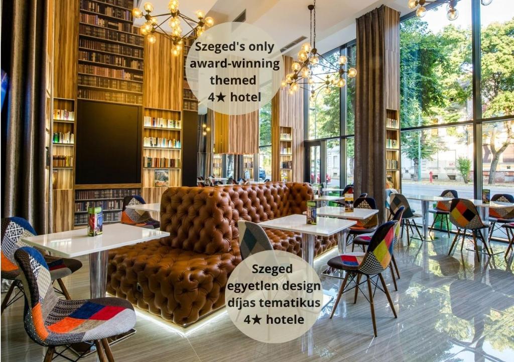 a restaurant with tables and chairs in a library at Science Hotel in Szeged
