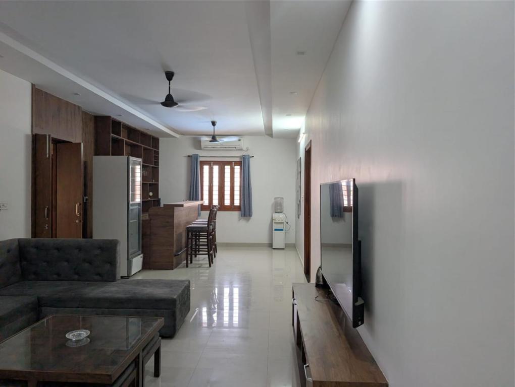 a living room with a couch and a table at Karmawas House in Jodhpur