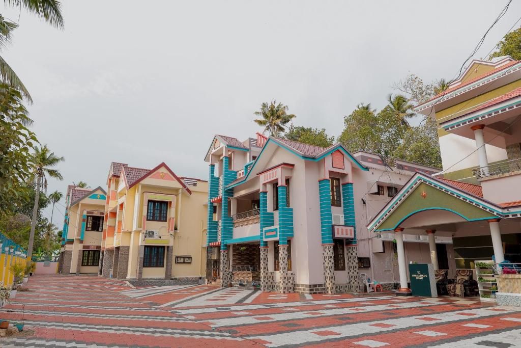 a row of colorful houses on a street at Varkala Escape Resort in Varkala