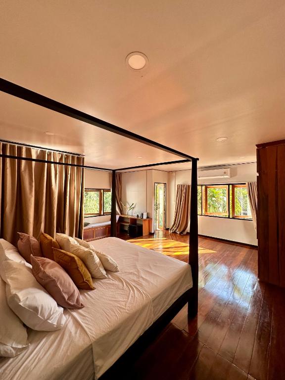 a bedroom with a bed with a black frame at Bearwolf Koh Kood in Ko Kood