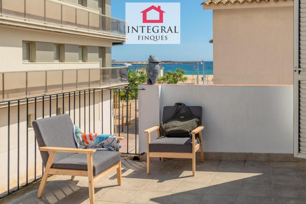 a child sitting in a chair on the balcony of a building at Casa Aiguamarina in Palamós