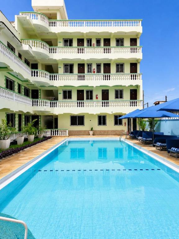 a large swimming pool in front of a building at Prestige Leisure Hotel in Mtwapa