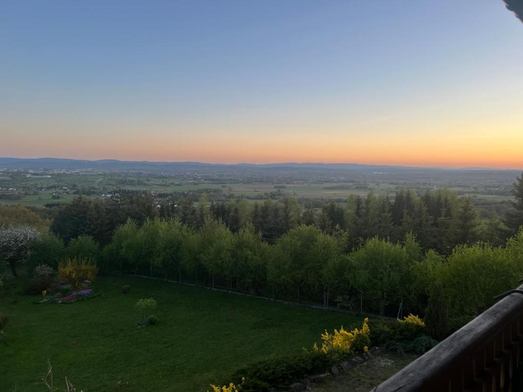 a view of a field with a sunset in the background at Podkamiencem in Odrzykoń
