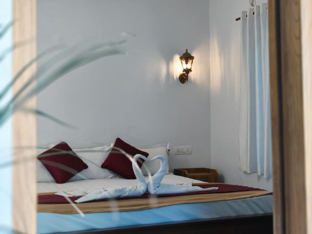 a bedroom with a bed with a glass window at Shampagne Villa in Cochin