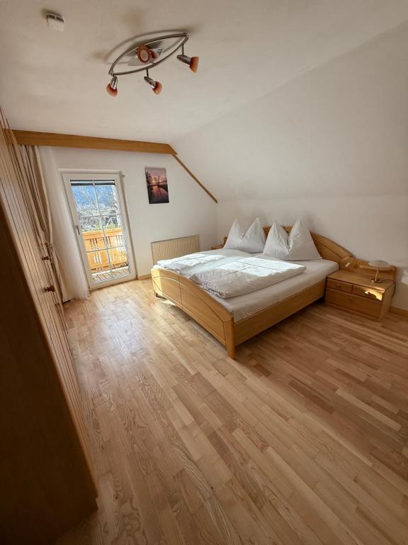 a bedroom with a large bed and a window at Landhäuschen in Kirchbach