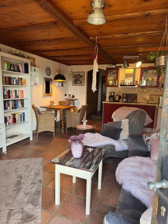 a living room with a couch and a table at Herzenslicht in Ingenried