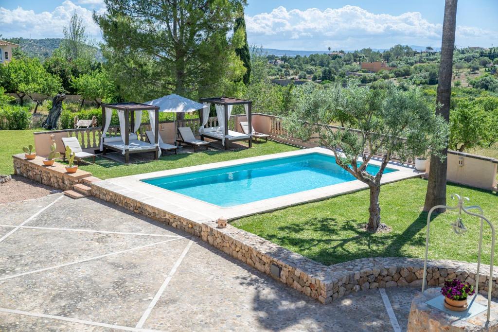 a pool in a yard with a table and chairs at Agroturismo Son Bauzanet in Palma de Mallorca