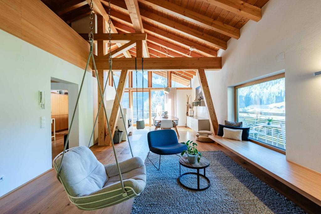 a living room with a swing hanging from the ceiling at Loft7 in Mittelberg