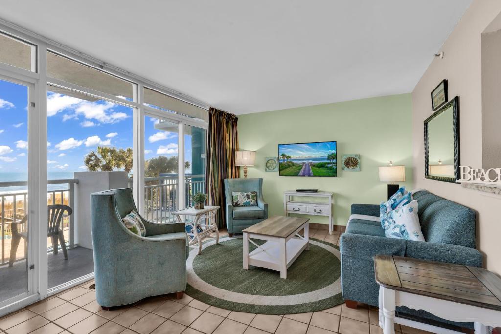 a living room with a couch and a table at Hosteeva Atlantica Oceanfront Condo in Myrtle Beach