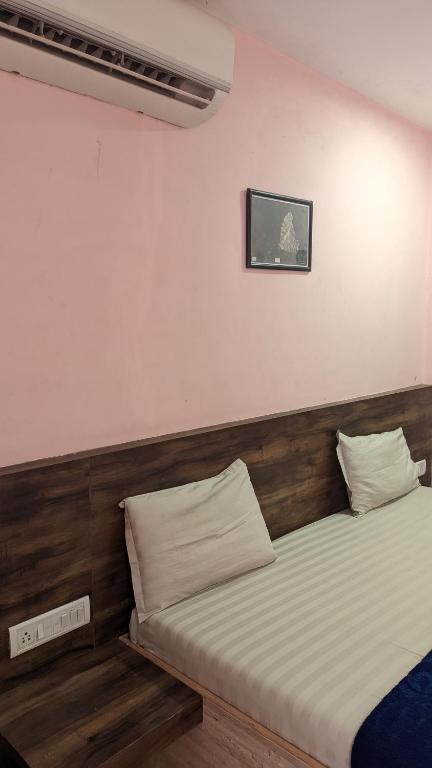 a bedroom with two beds at Hotel M N Matheran in Matheran