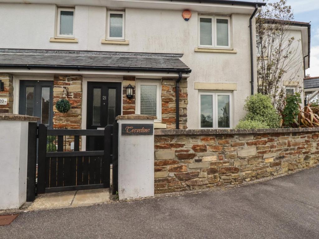 a house with a gate and a stone wall at Treveline in Bodmin