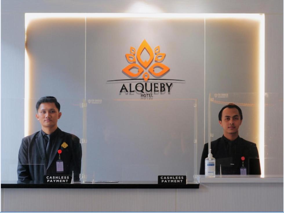 two men standing in front of a display at Alqueby Hotel Bandung in Bandung