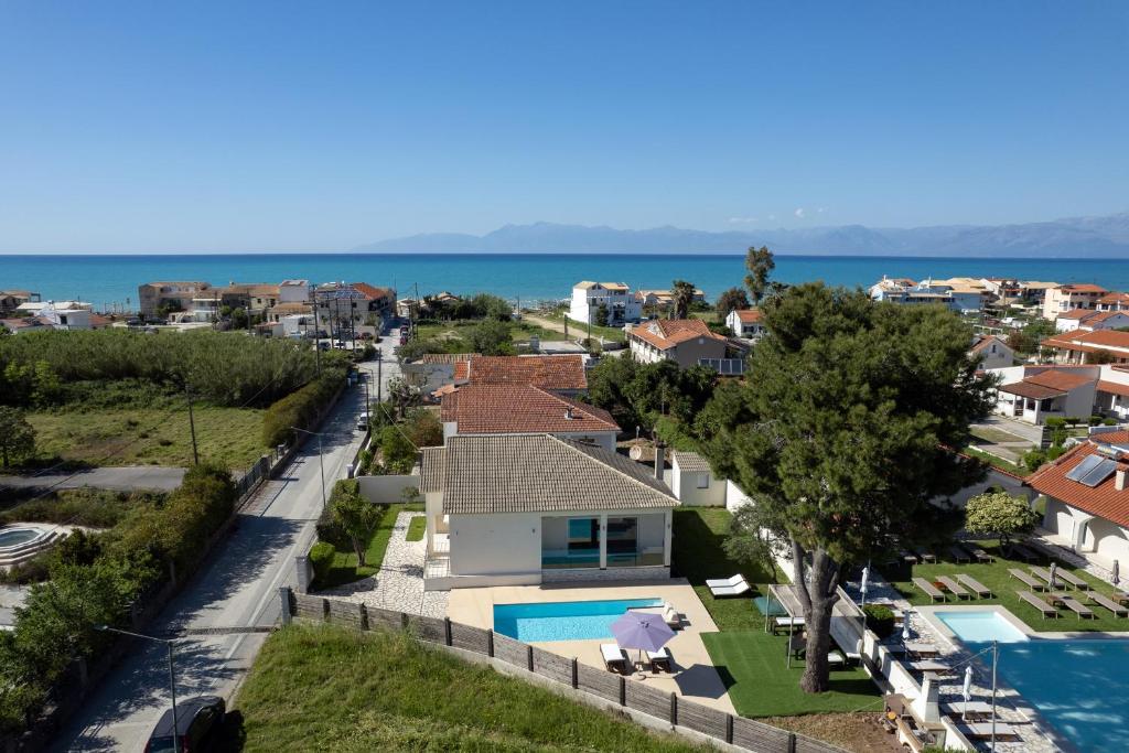 an aerial view of a house with a swimming pool at Beach Villa Christina by PosarelliVillas in Acharavi