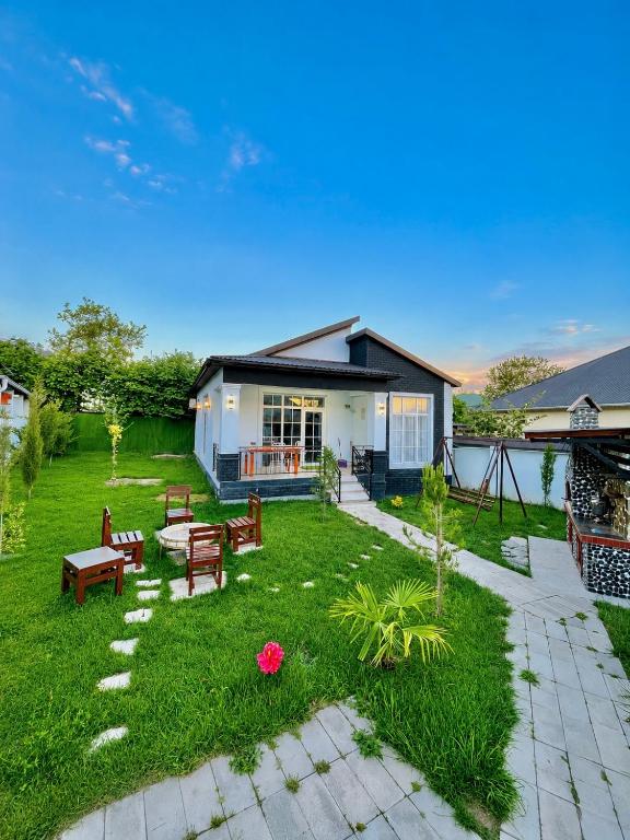 a yard with benches and a house at Gabala Luxury Nature Villa in Gabala