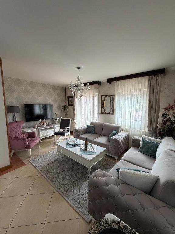 a living room with a couch and a table at LuxHouseNiksic in Nikšić