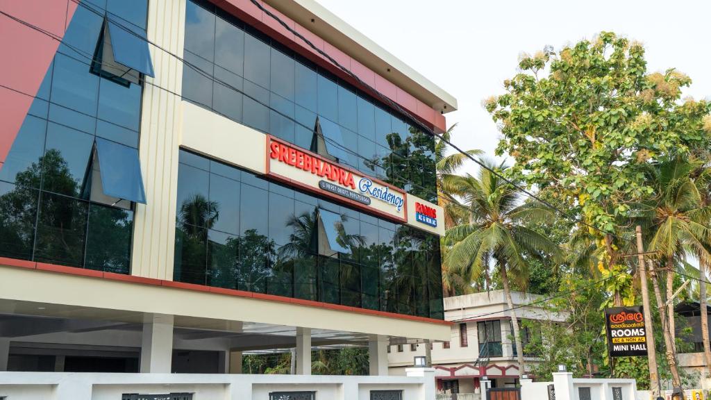 a building with a sign on the side of it at Sreebhadra Residency in Chavara
