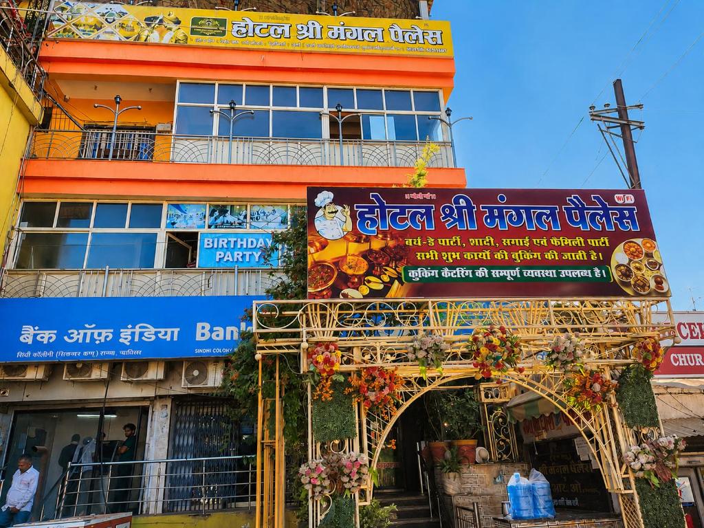 a building with a sign in front of it at Shri Mangal Palace in Gwalior