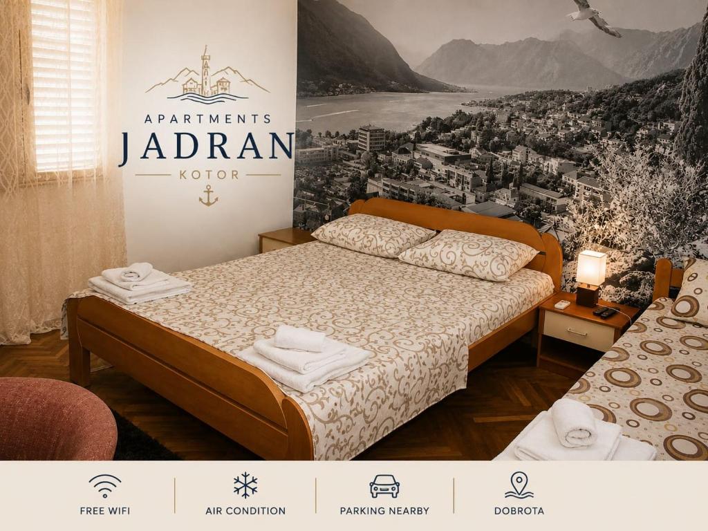 a bedroom with a bed and a poster of a city at Apartman Jadran Private Parking in Dobrota