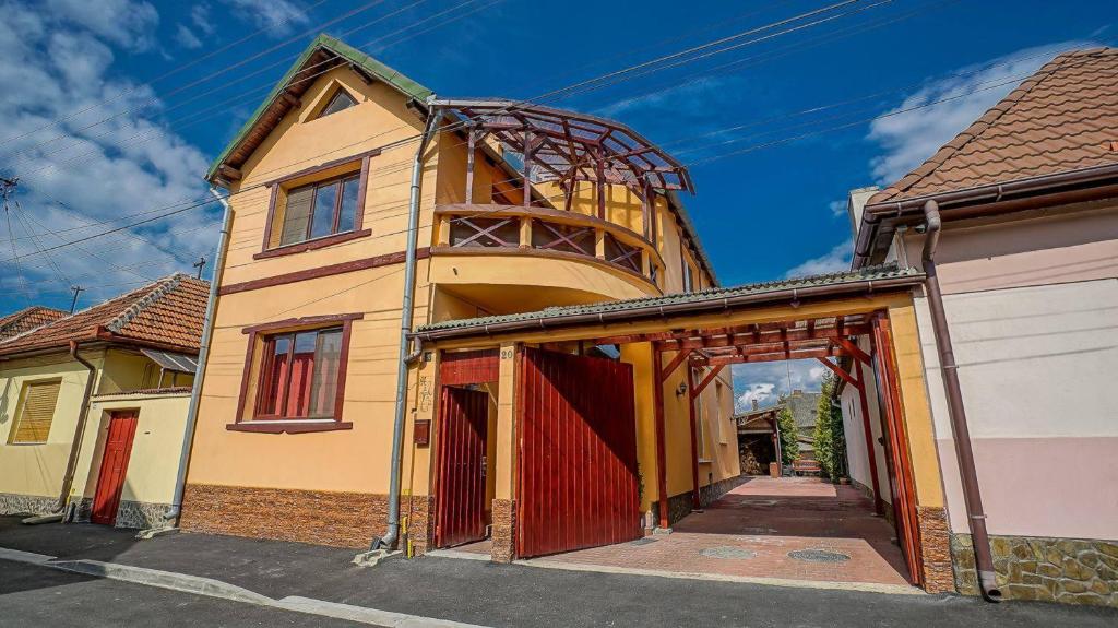 a building with an archway on the side of it at Pensiunea Hanna in Braşov