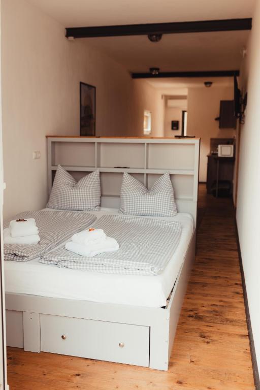 a large white bed with white pillows on it at Fun & Relax Park Thurnau in Thurnau