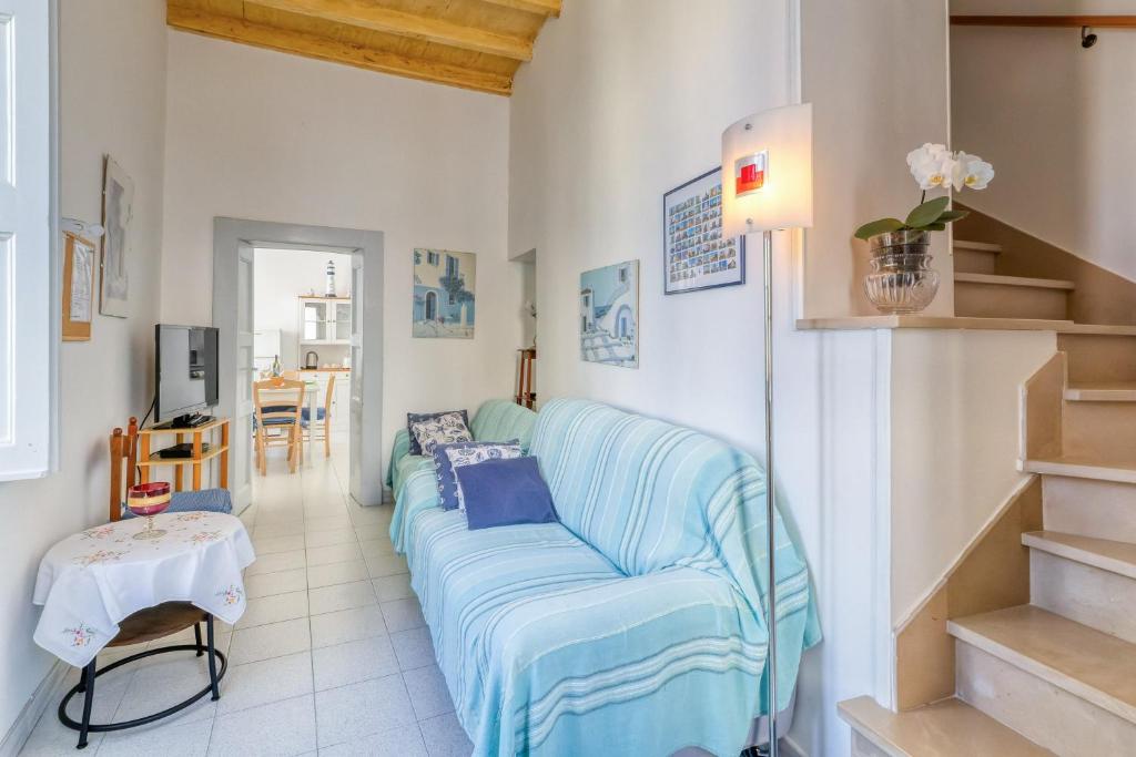 a living room with a blue couch and a table at Casa in Via Seminario Otranto in Otranto