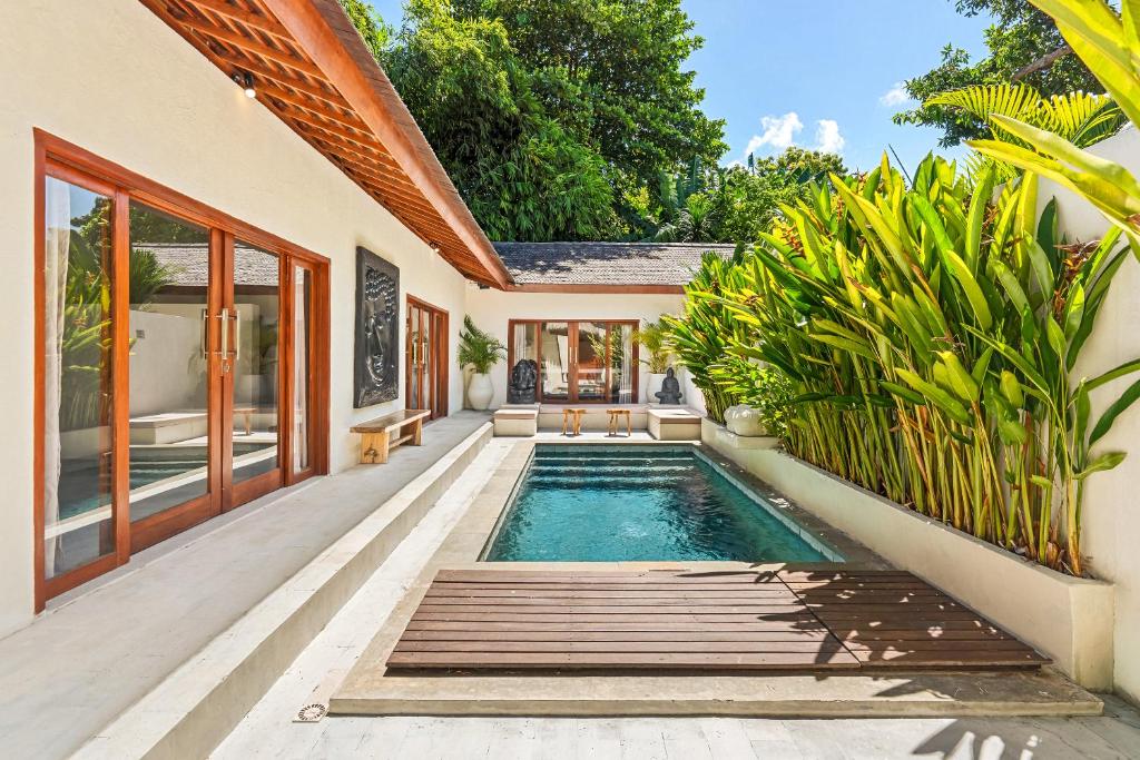 a swimming pool in the backyard of a house at Tropical Villas Complex in Jimbaran
