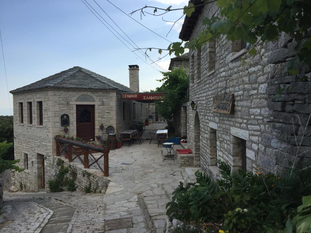 a stone building with a patio in front of it at Elafotopos Hotel in Elafotopos