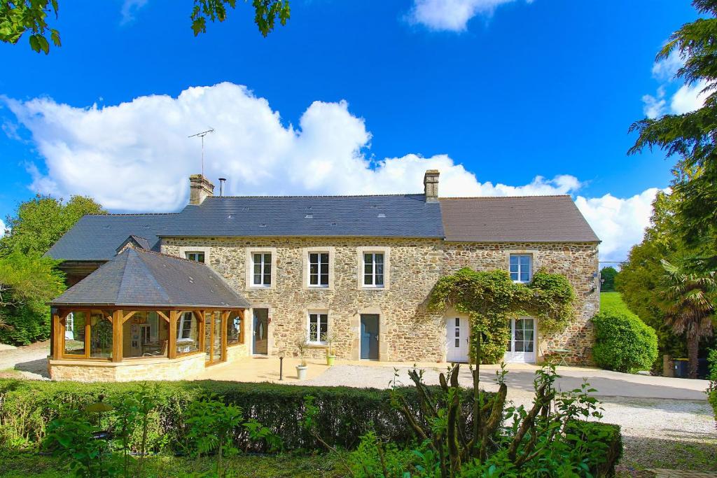 a large stone house with a gazebo in front of it at Chambres D'hôtes Dans Le Cotentin in Teurthéville-Bocage