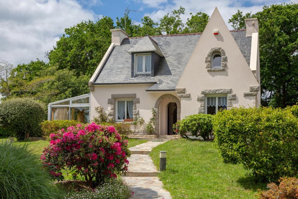 a white house with a gray roof at Chez Coco in Trégunc