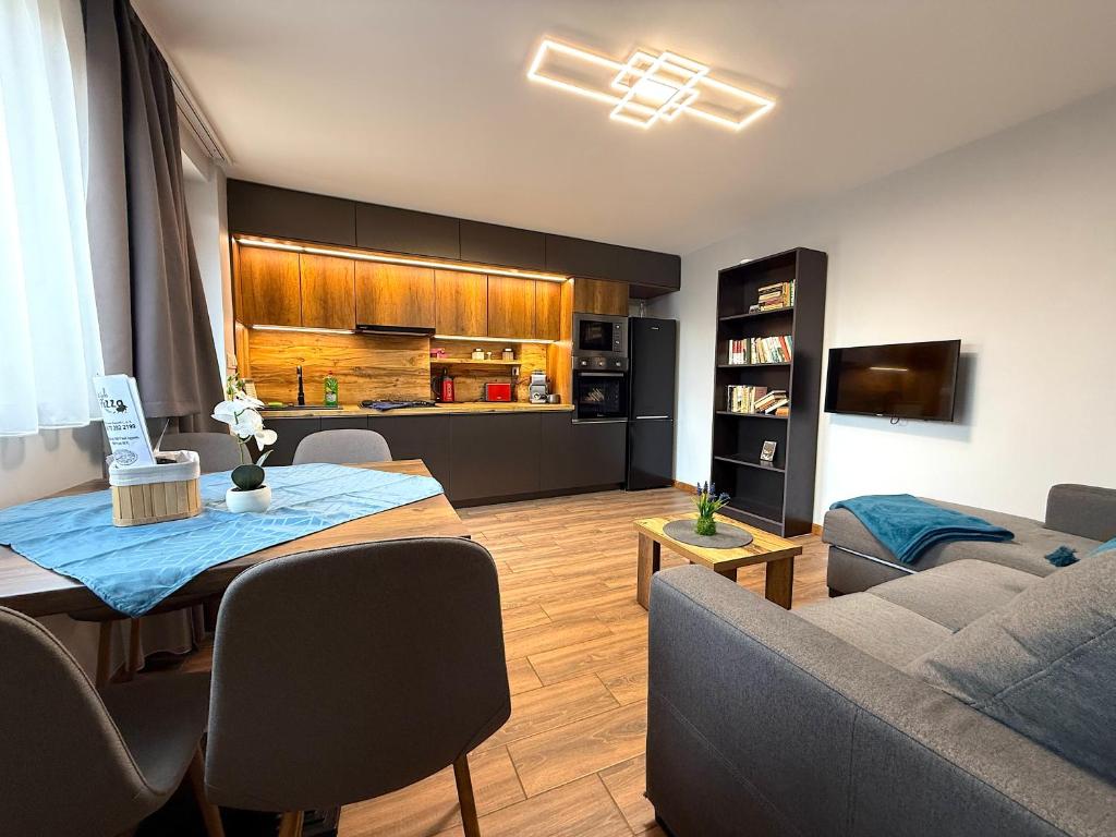 a living room with a couch and a table at Paradiso Apartmanház in Gyula