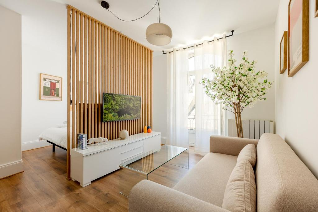 a living room with a couch and a table at Downtown by Max, Refuge in city center in Mulhouse