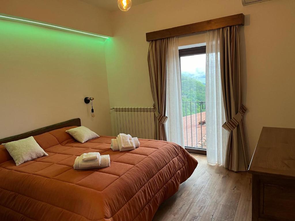 a bedroom with a bed with two towels on it at Borgo Izzo 2 in San Fele