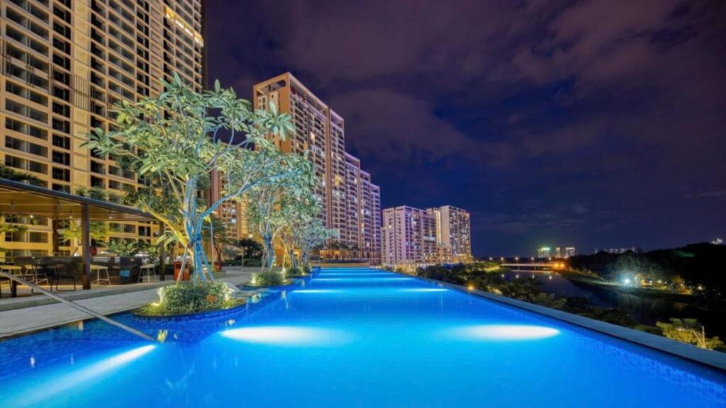 a large swimming pool in a city at night at Premium Midtown serviced apartment in Ho Chi Minh City