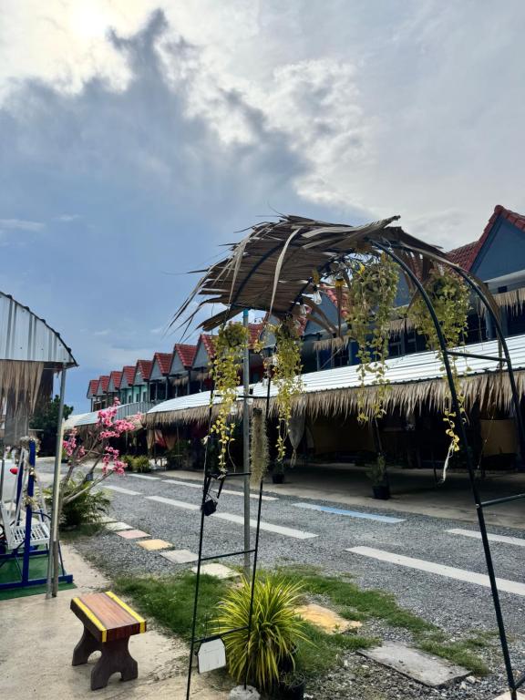 an umbrella on a pole on a street at ภูมิคิมมินทร์ รีสอร์ท & สปา in Ban Chai Na
