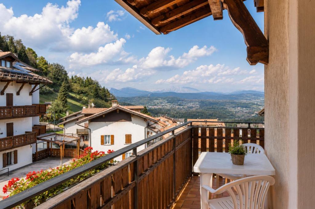 a balcony with a table and chairs and a view at Erica in Folgaria
