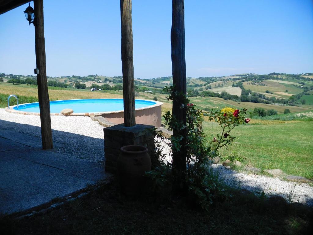 a view from the outside of a house with a swimming pool at Casa Rustica mit privatem Pool zur alleinigen Nutzung in Corinaldo