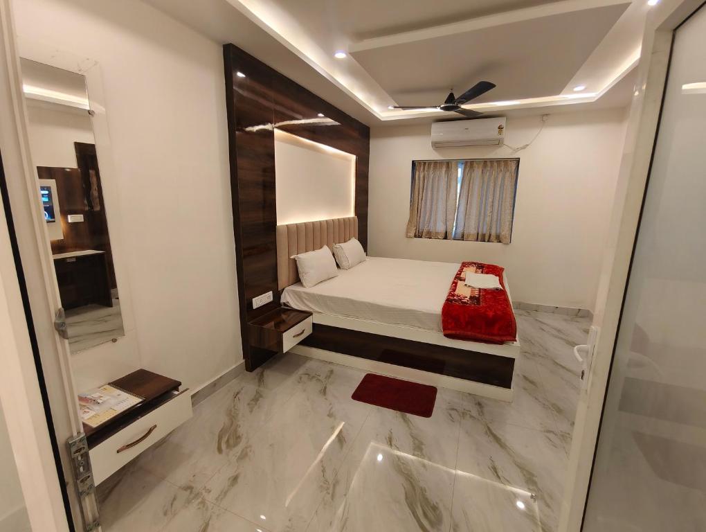 a small bedroom with a bed and a window at Sunview Resort in Mandarmoni