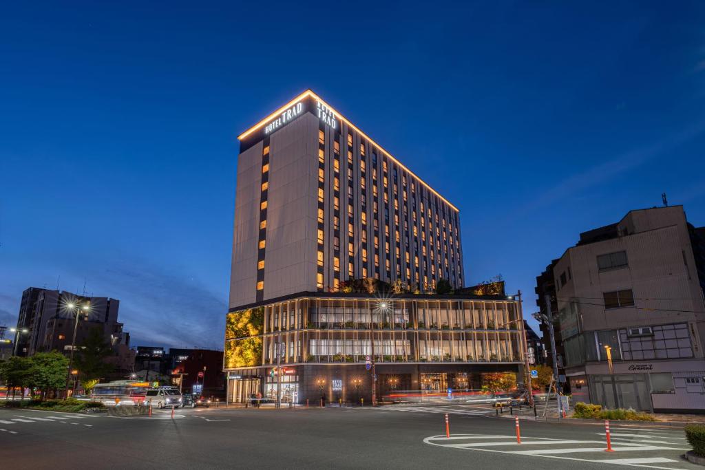 a tall building with a sign on top of it at Hotel Trad Hakata in Fukuoka
